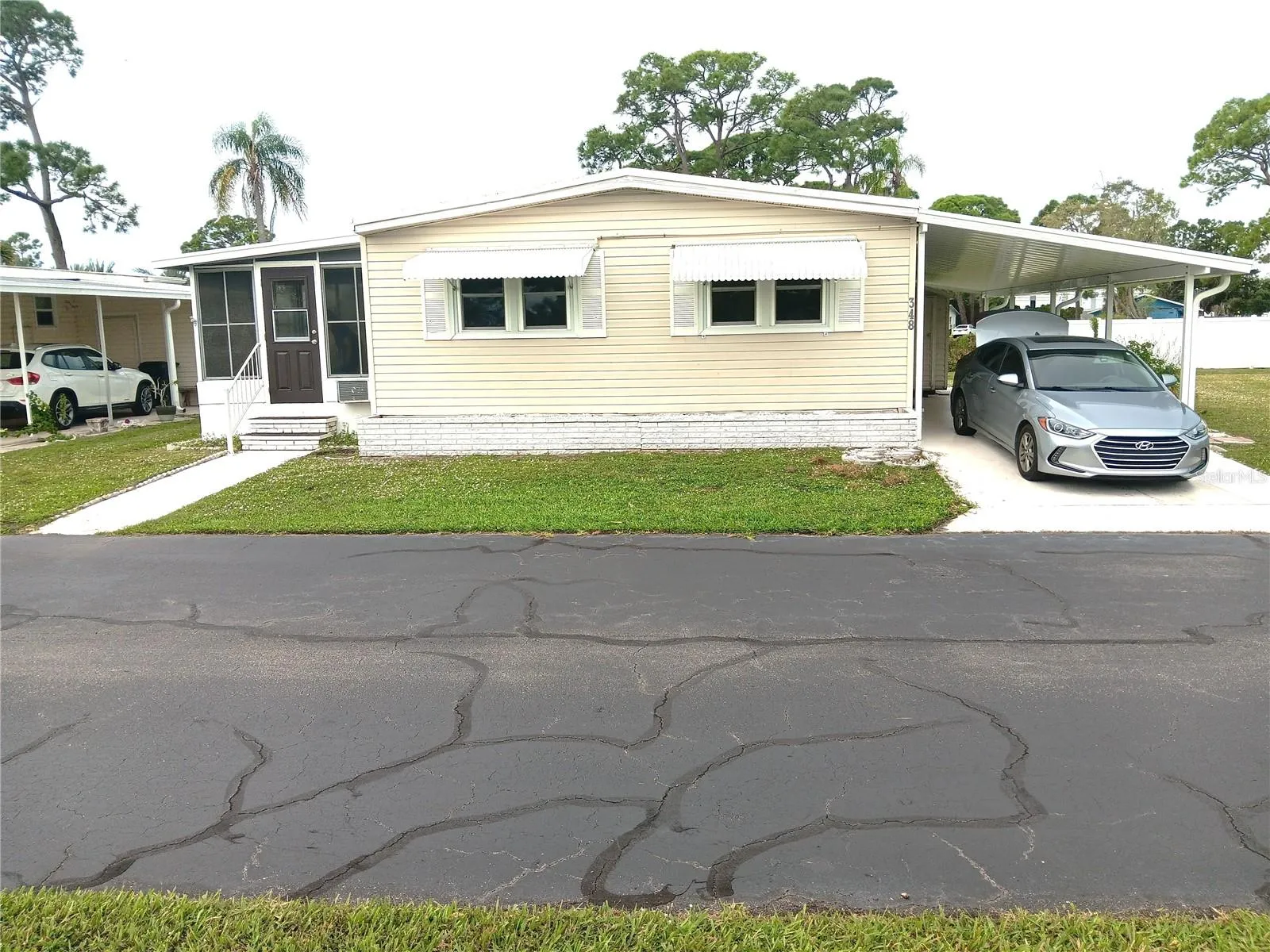 Notice 2 cars parked under 2-year-old car port.  New shed, too.