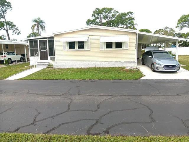 Notice 2 cars parked under 2-year-old car port.  New shed, too.