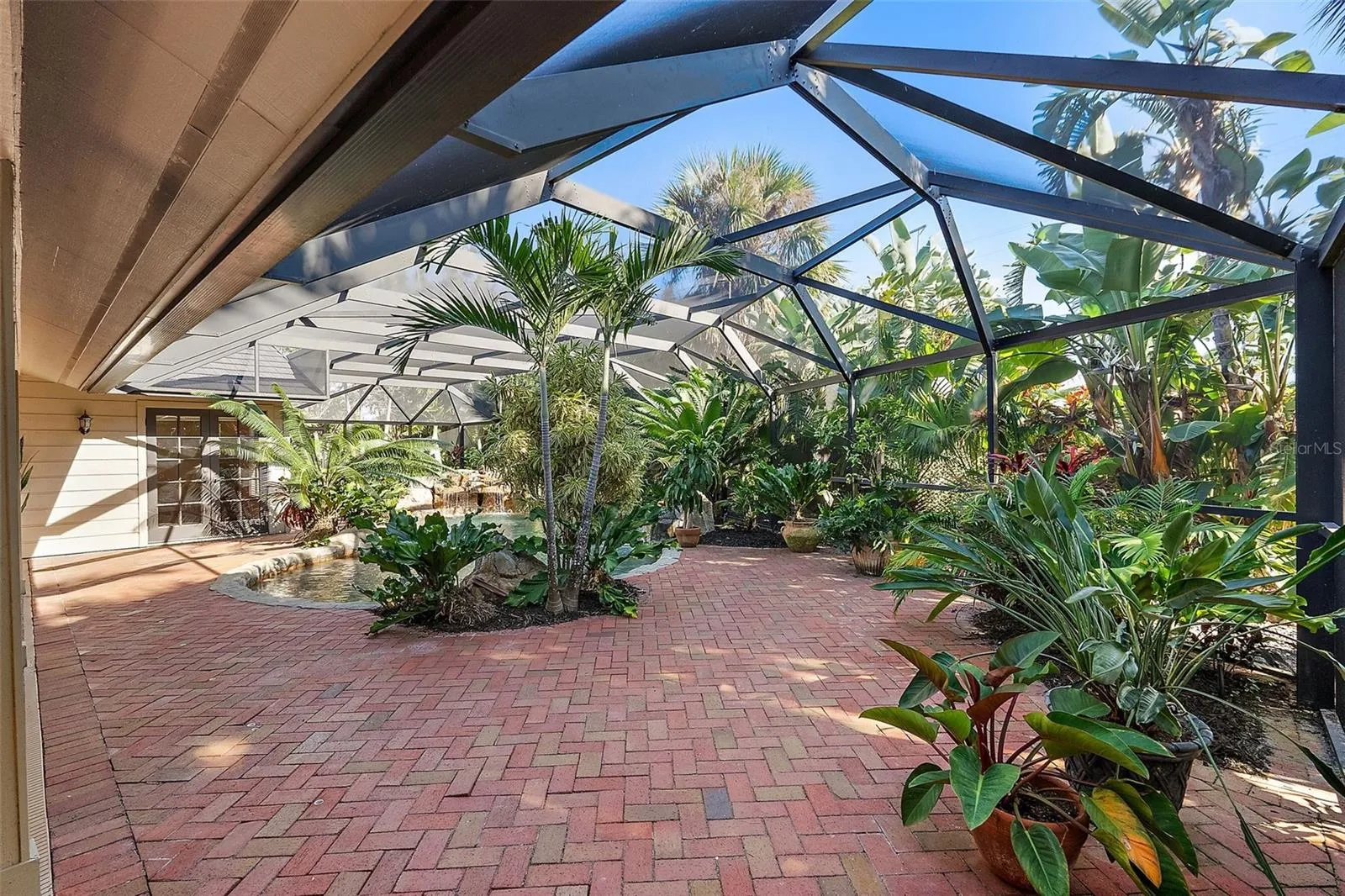 Large pavered patio with enclosure