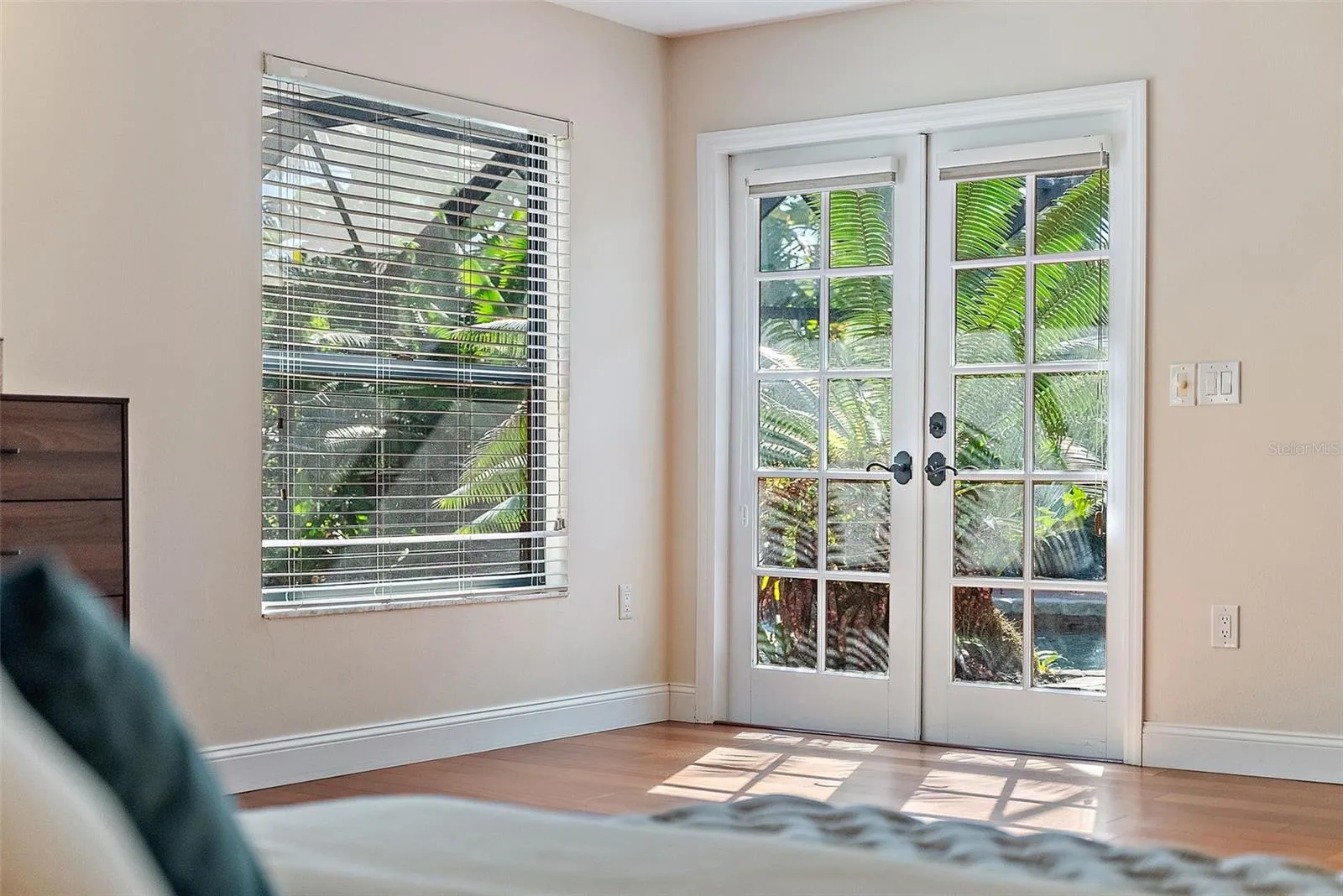 Primary Bedroom w/ French doors to the pool