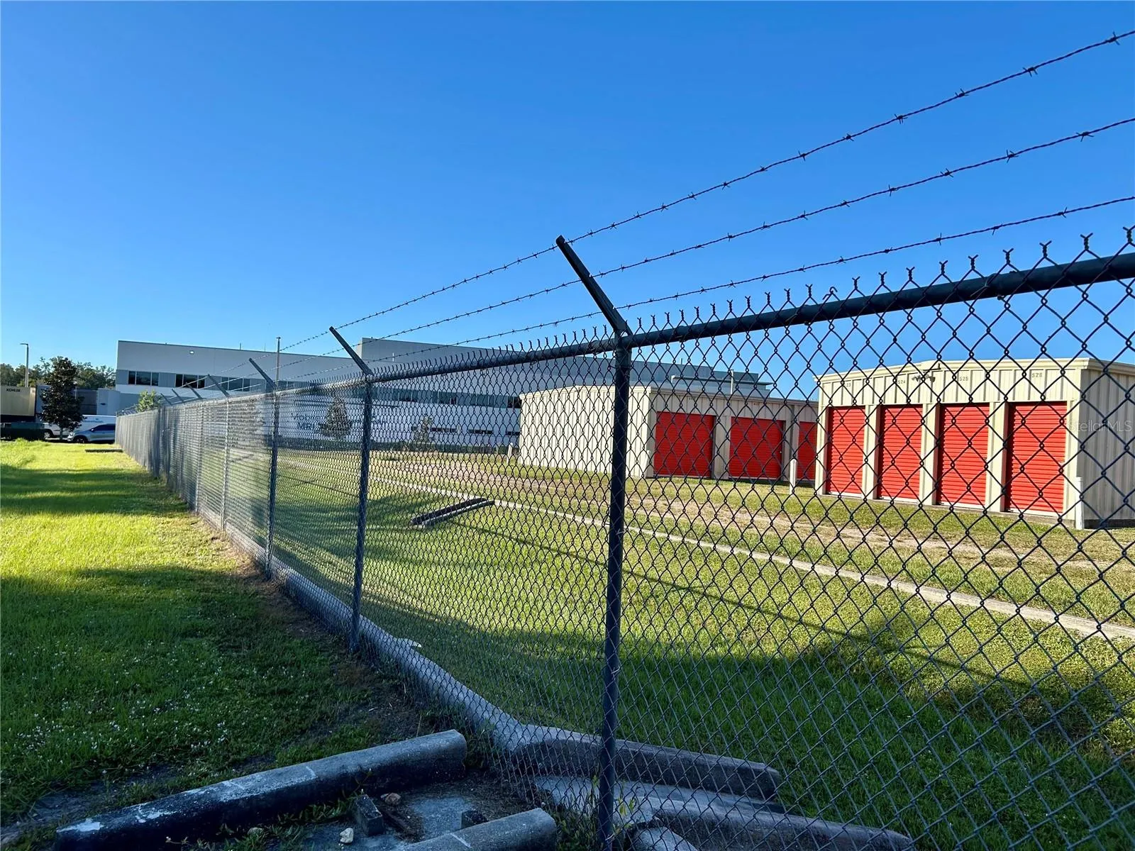 View from property looking southwest toward storage unit buildings and hospital