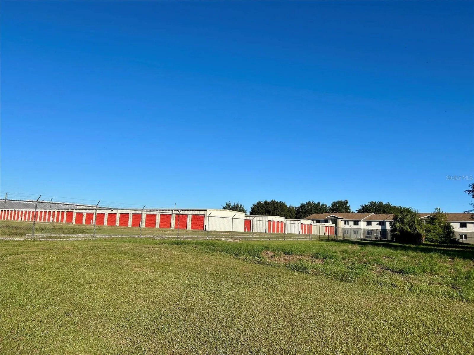 View from property looking northwest to storage unit buildings and apartment complex