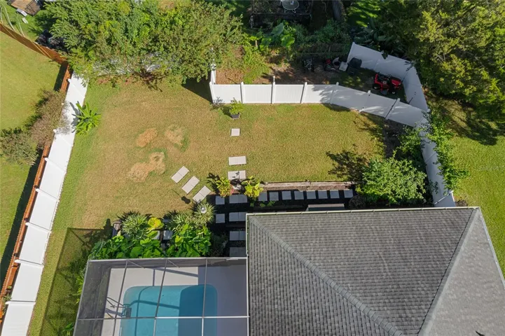 Spot is the grass were the fire pit, Outdoor umbrella and chairs.