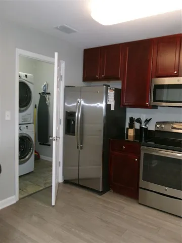 Fully equipped Kitchen with beautiful wood cabinets, stainless steel appliances and laundry room