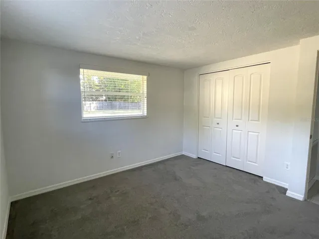 Guest bedroom with brand new carpet.