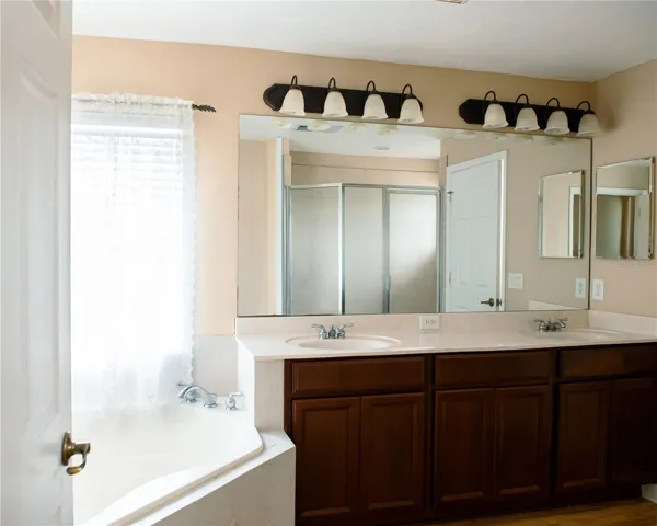 Primary Bathroom w/ tub, walk in shower and dual sinks