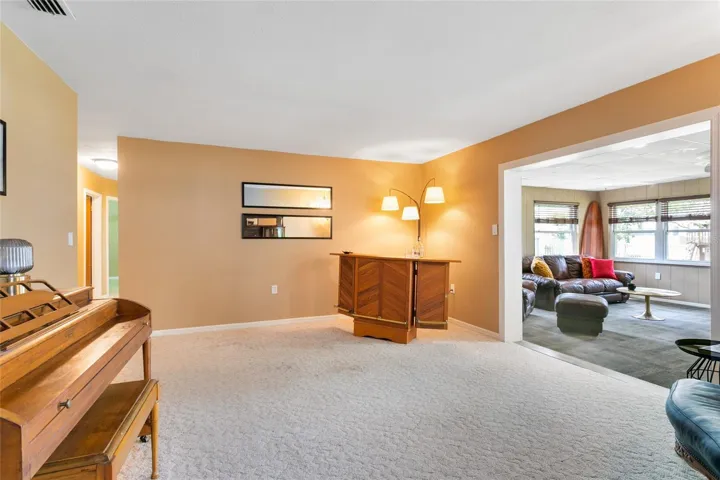 Living room off kitchen overlooking additional living space