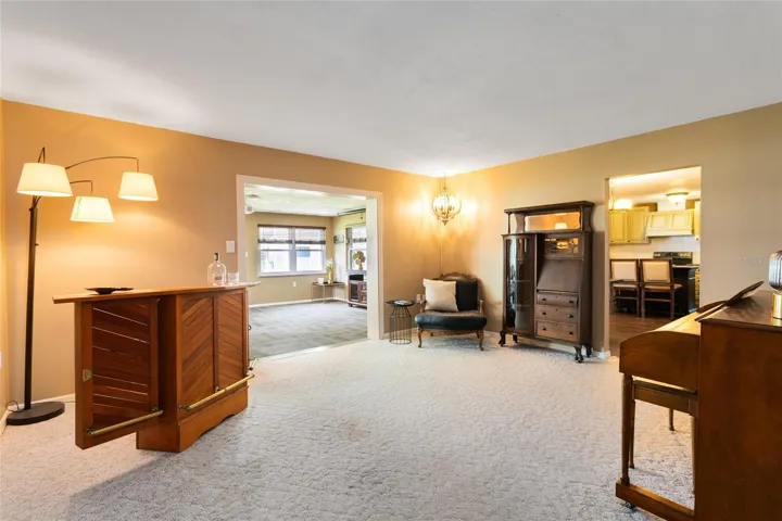 Living room off kitchen overlooking additional living space