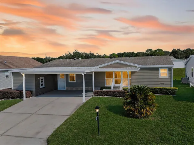 Front View with Double Carport for Side By Side Parking, Front Porch as well as Rear Screened Porch