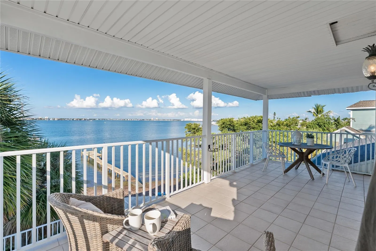 Finished vinyl soffit ceiling with a clean beadboard appearance.  Wake up to sunrise views over Boca Ciega Bay. Enjoy your morning cup of coffee with the water views. Tile balcony with finished ceiling.