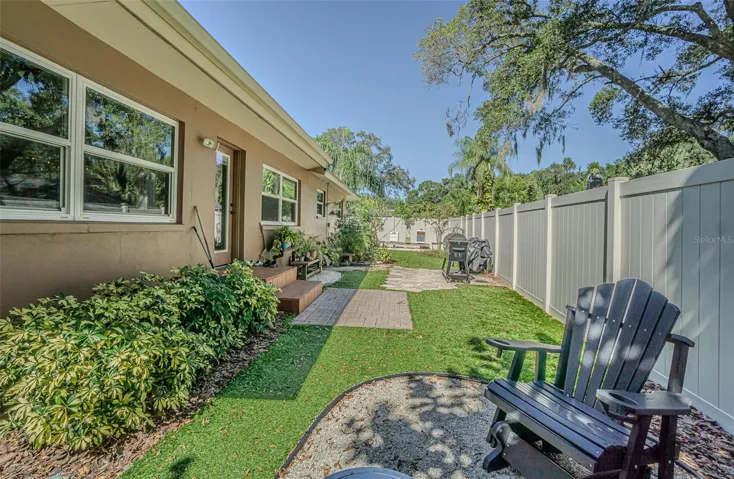 Backyard seating areas with artificial turf.