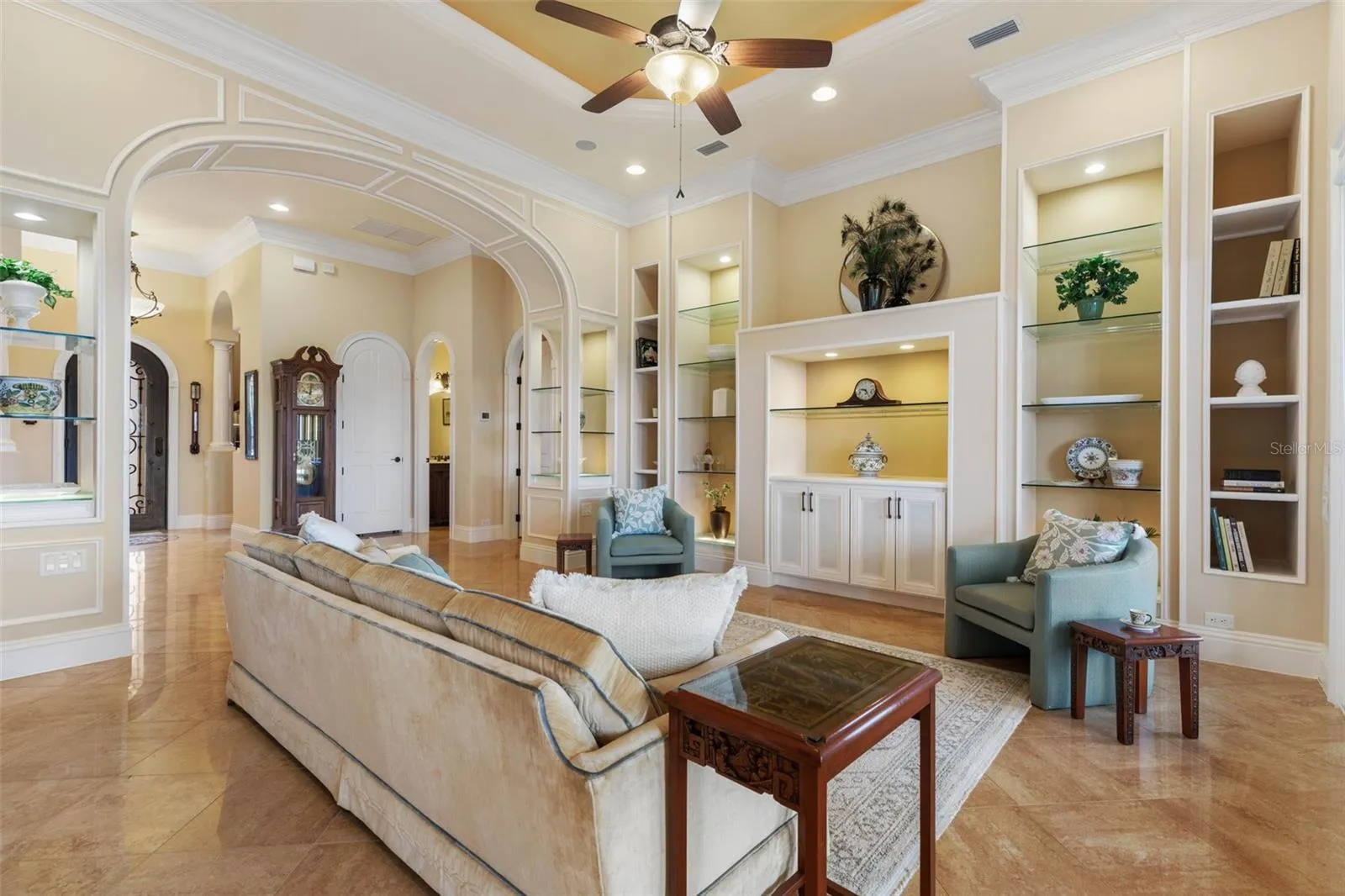 Living Room with custom cabinetry and lit built-ins