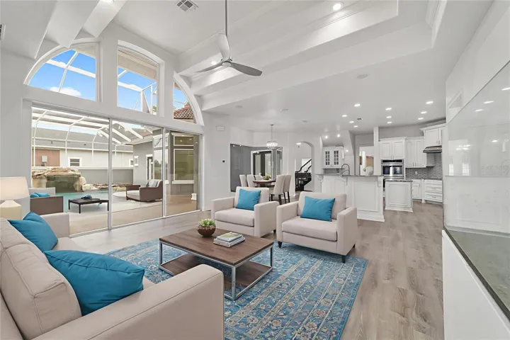 Virtually Staged Family Room with Tray Dual Tray Ceiling with Access to Courtyard and Swimming Pool with Screen Enclosure