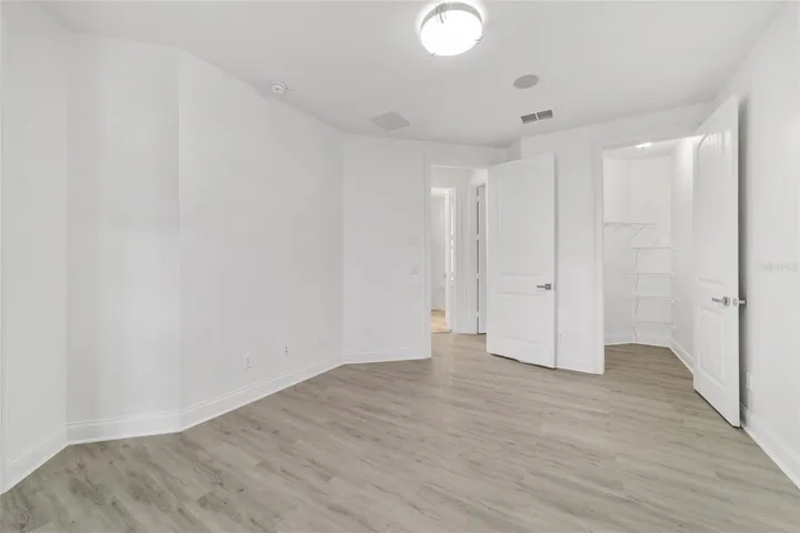 Upper Level Bedroom #3 with Private Balcony and Walk-In Closet