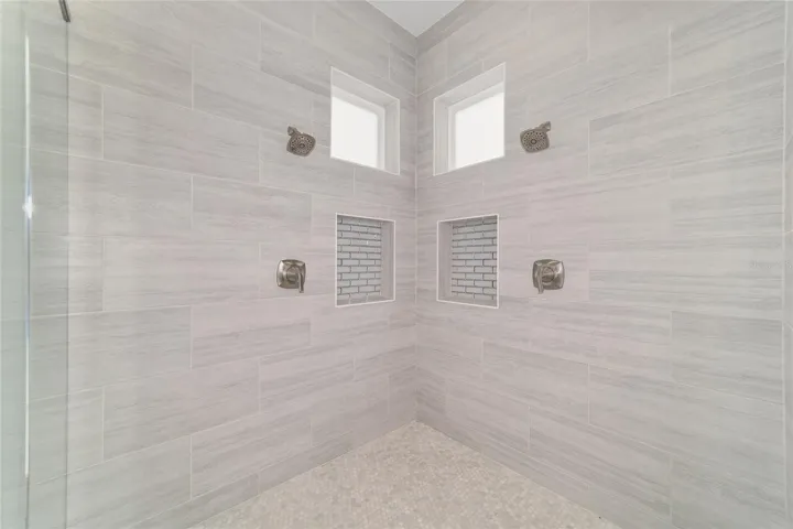Main Level Primary Bedroom with Large Tile / Seamless Glass Shower