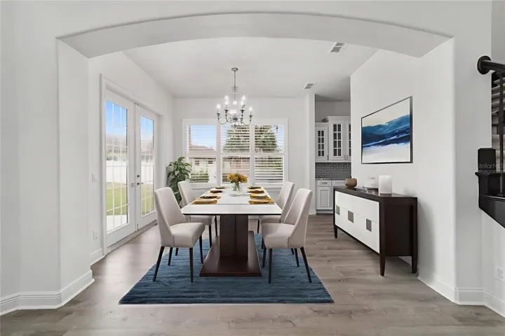 Virtually Staged Dining Room with Access to Rear Patio