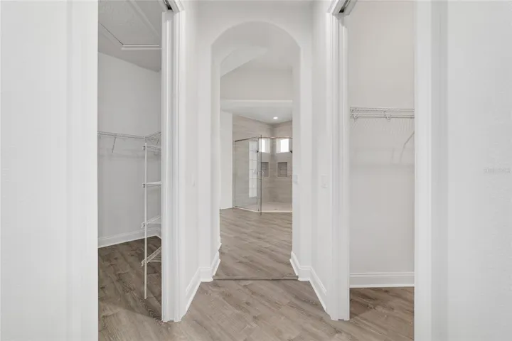 Main Level Primary Bedroom Hallway with Dual Walk-In Closets