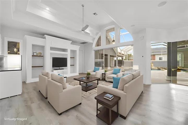 Virtually Staged Family Room with Built-Ins and Amazing Courtyard / Pool Views