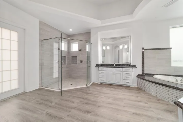 Main Level Primary Ensuite with Access to Courtyard and Swimming Pool / Hot Tub