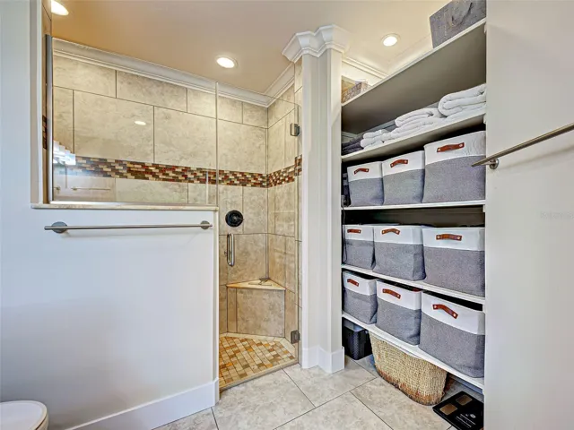 The large walk-in shower is tastefully tiled.
