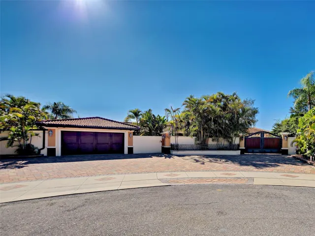 This front of this home makes a statement.  Beautiful pavers, gorgeous gate and the tile roof is absolutely stunning.
