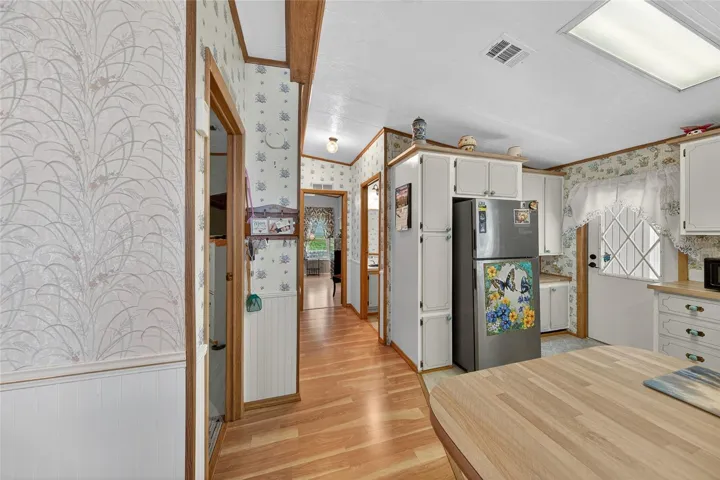 Kitchen looking down the hallway to bedrooms and  baths
