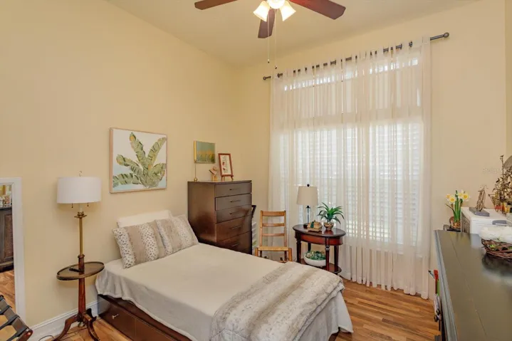 Bedroom number three.  Lighted ceiling fan. Shutters on the window.