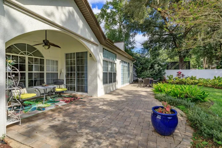 The covered patio has an electric screen to give privacy and sun shielding.