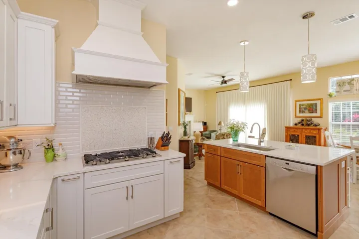 Pretty updated hood.  Gas cooktop.  Look at the backsplash!    White is so clean looking!