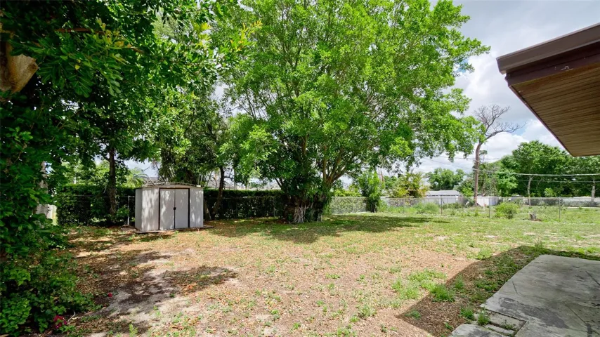 Expansive Backyard with Storage Shed and Majestic Oak