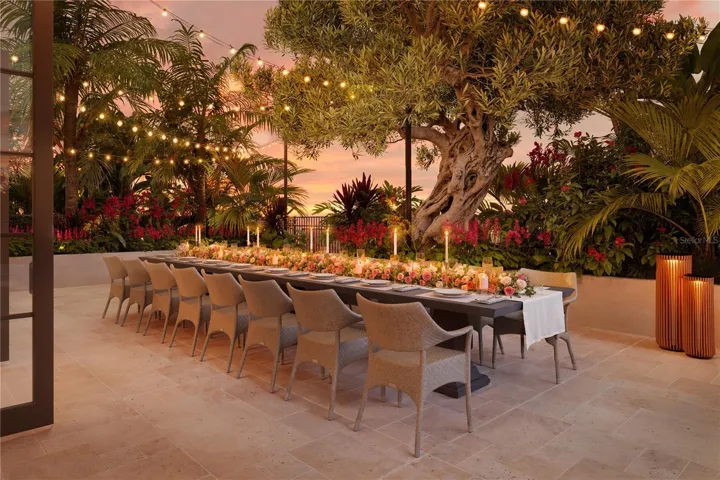 A beautifully landscaped garden terrace offers an intimate outdoor dining setting, where lush greenery and thoughtful design create a private oasis for residents to relax and entertain in style.