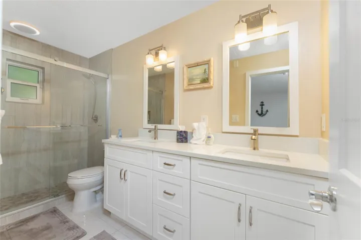 Primary Bathroom (en suite) with new walk in shower and dual sinks and soft close cabinet drawers