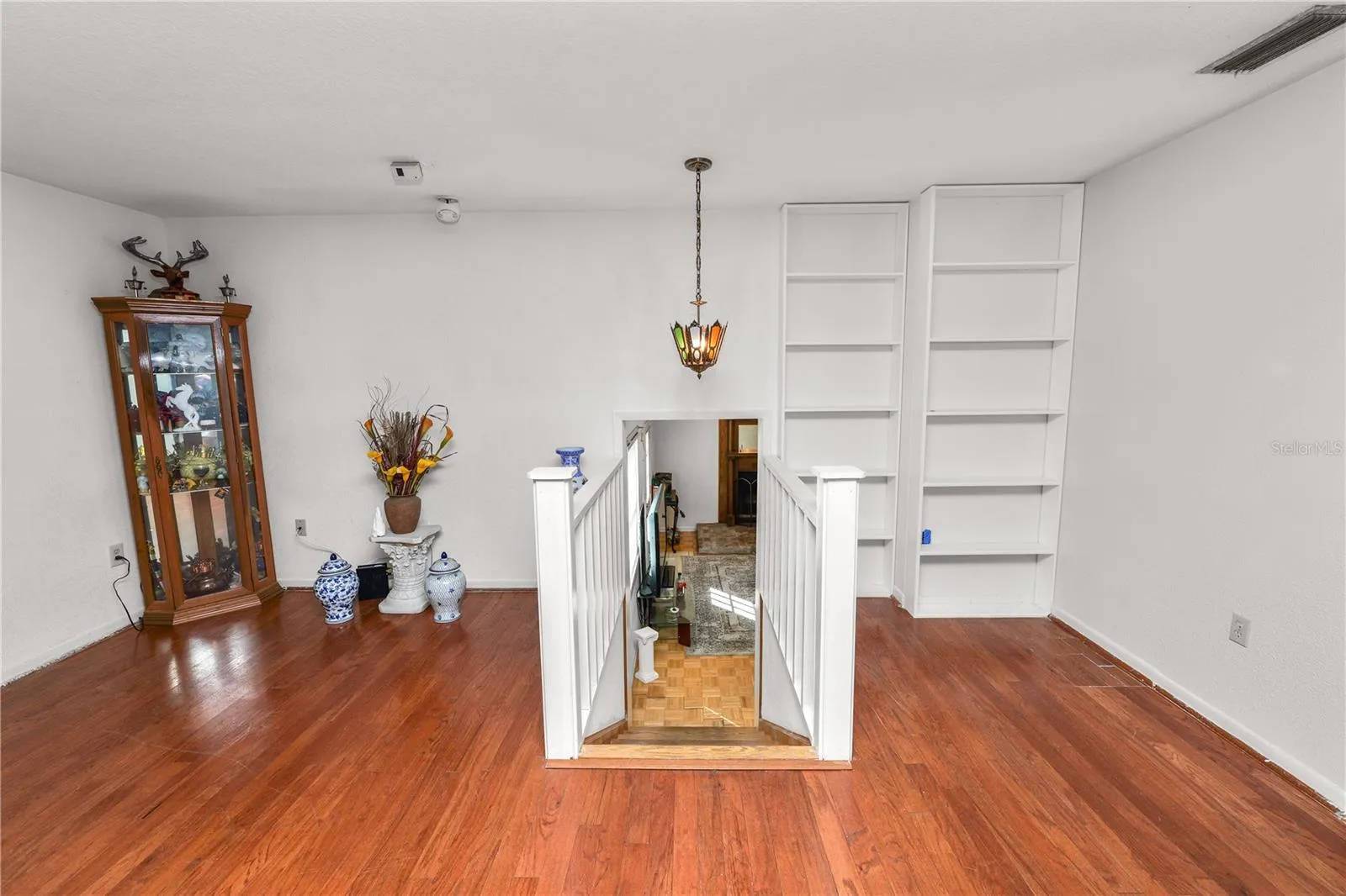 Step downstairs to Family Room and to Primary Room Suite