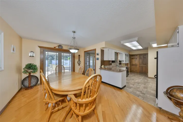 LARGE AREA FOR DINING INTO KITCHEN WITH WOOD FLOORS
