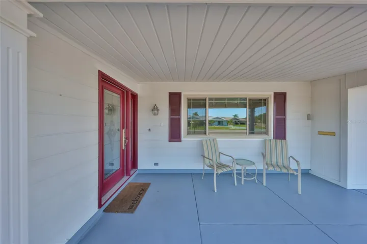 COVERED FRONT ENTRY WITH HEAVY DUTY LEADED GLASS DOOR WITH SIDELIGHT.