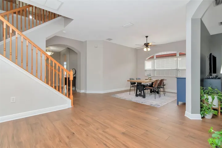 View from Entrance to kitchen —- Staircase, hallway to Entry, Dining Room, and Family room entrance to the right
