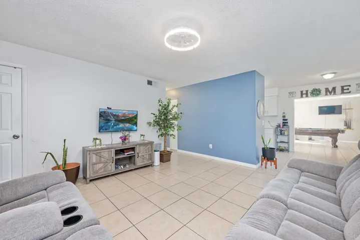Living area flows into the kitchen and beyond into the large family room.