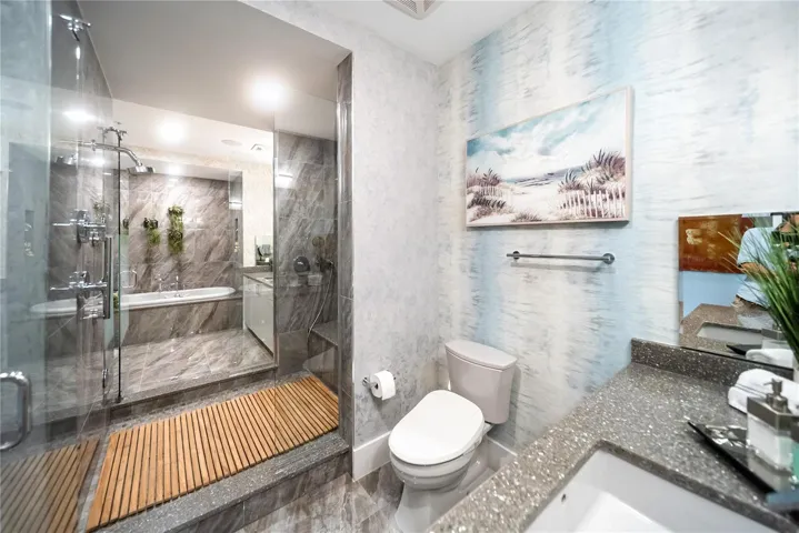 Primary bathroom - his and her side connected by spa-like shower