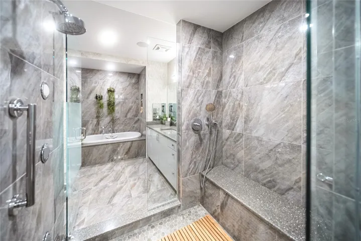 Spa-like custom shower, connecting his and her side