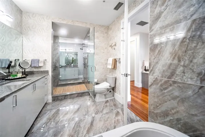 Primary bathroom - his and her side connected by spa-like shower