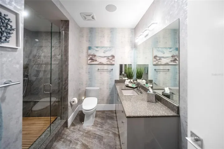 Primary bathroom - his and her side connected by spa-like shower