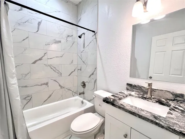 Guest Bathroom w/ Tub & Shower Combo and Granite Countertops
