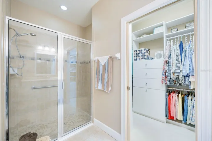 Enjoy convenience in this ensuite featuring double vanities, a roomy walk-in shower, and a generous closet for all your essentials.