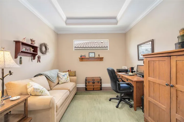 Stylish and serene, this den features an inset ceiling with crown moulding, a high-set privacy window that fills the space with natural light, and endless possibilities as a home office, yoga retreat, or creative studio.