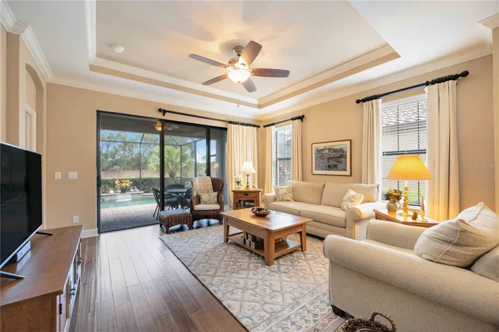 Another view of this Florida living room with doors that open to the lanai and pool.