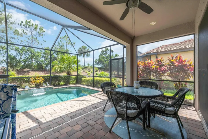 Your private paradise awaits! Enjoy a covered lanai, sparkling pool with a waterfall feature, elegant paver deck, and lush mature landscaping that creates the perfect Florida retreat.