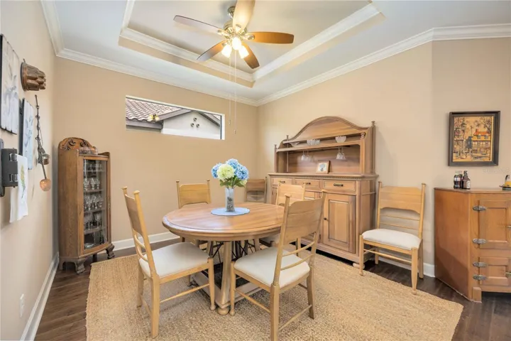 The large, open dining area features tray ceilings, crown moulding and a high-set window for light and privacy.