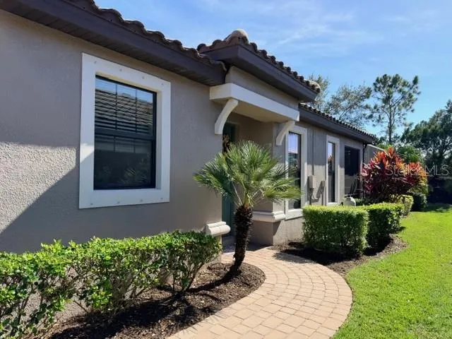 Gorgeous landscaping and a gently winding path lead you home.