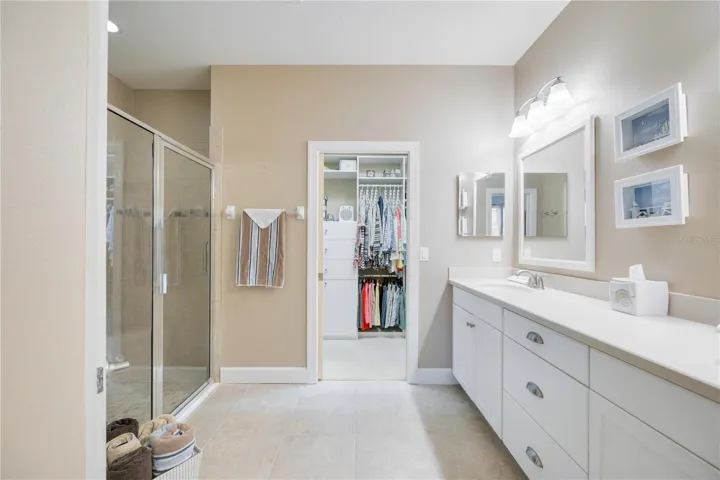 The luxurious ensuite bathroom features dual vanities, a walk-in shower, and a generous walk-in closet, ensuring ample storage.