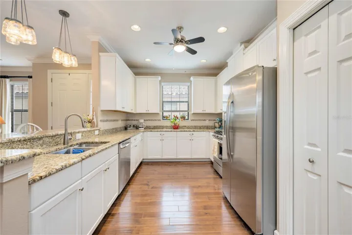 The light and modern kitchen is a chef’s delight, boasting stainless steel appliances, abundant counter space, and ample cabinetry for all your culinary needs.